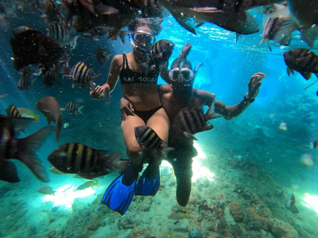 Snorkeling couple stail Cay thunderball