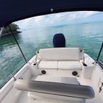 The view from the back of a boat on a Staniel Cay Adventure, surrounded by clear blue water.
