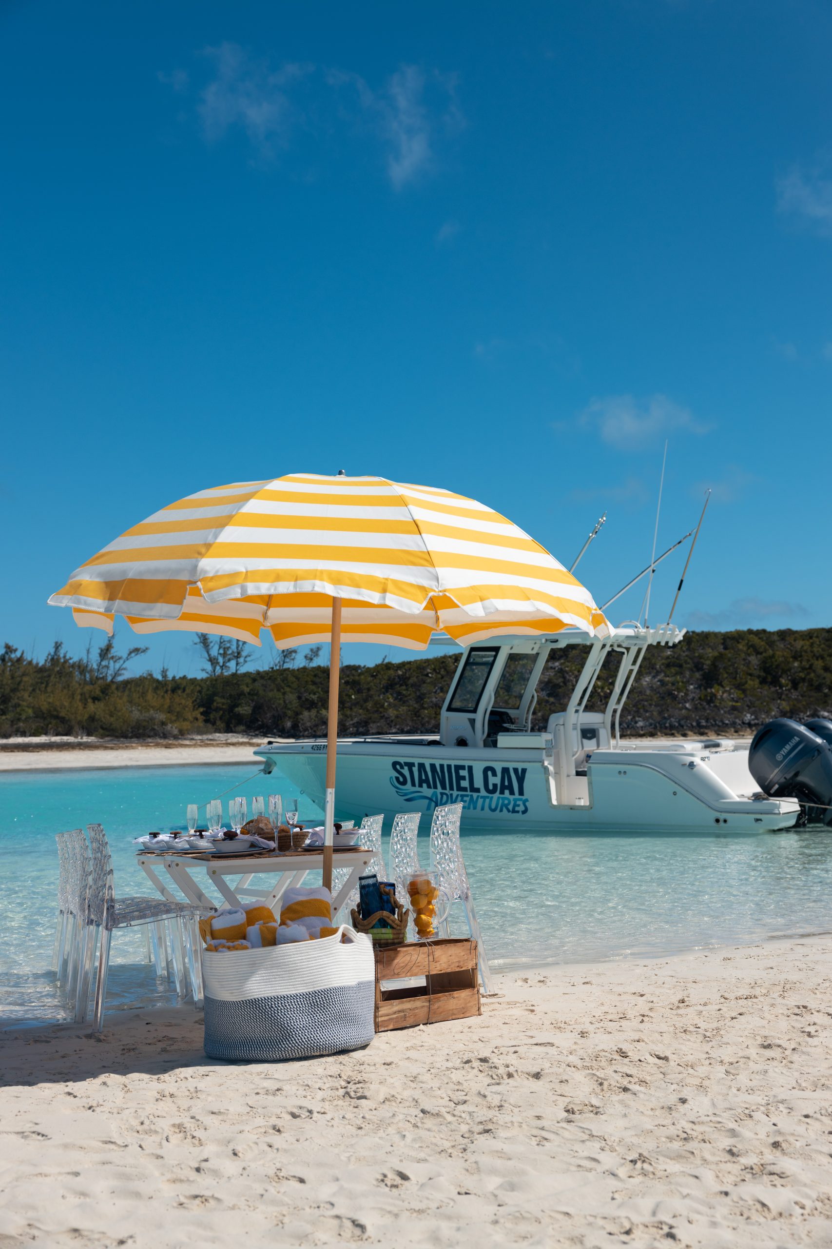 A yellow and white umbrella perfect for Staniel Cay Boating.