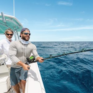 Two men on a boat in the ocean, enjoying a fishing trip in Exuma Cays, Bahamas.