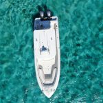 An aerial view of a white boat in the ocean during a Scuba Diving Exuma tour.