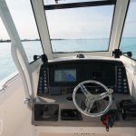Staniel Cay, Exuma Bahamas A boat's helm station with navigation equipment overlooking a calm blue sea.