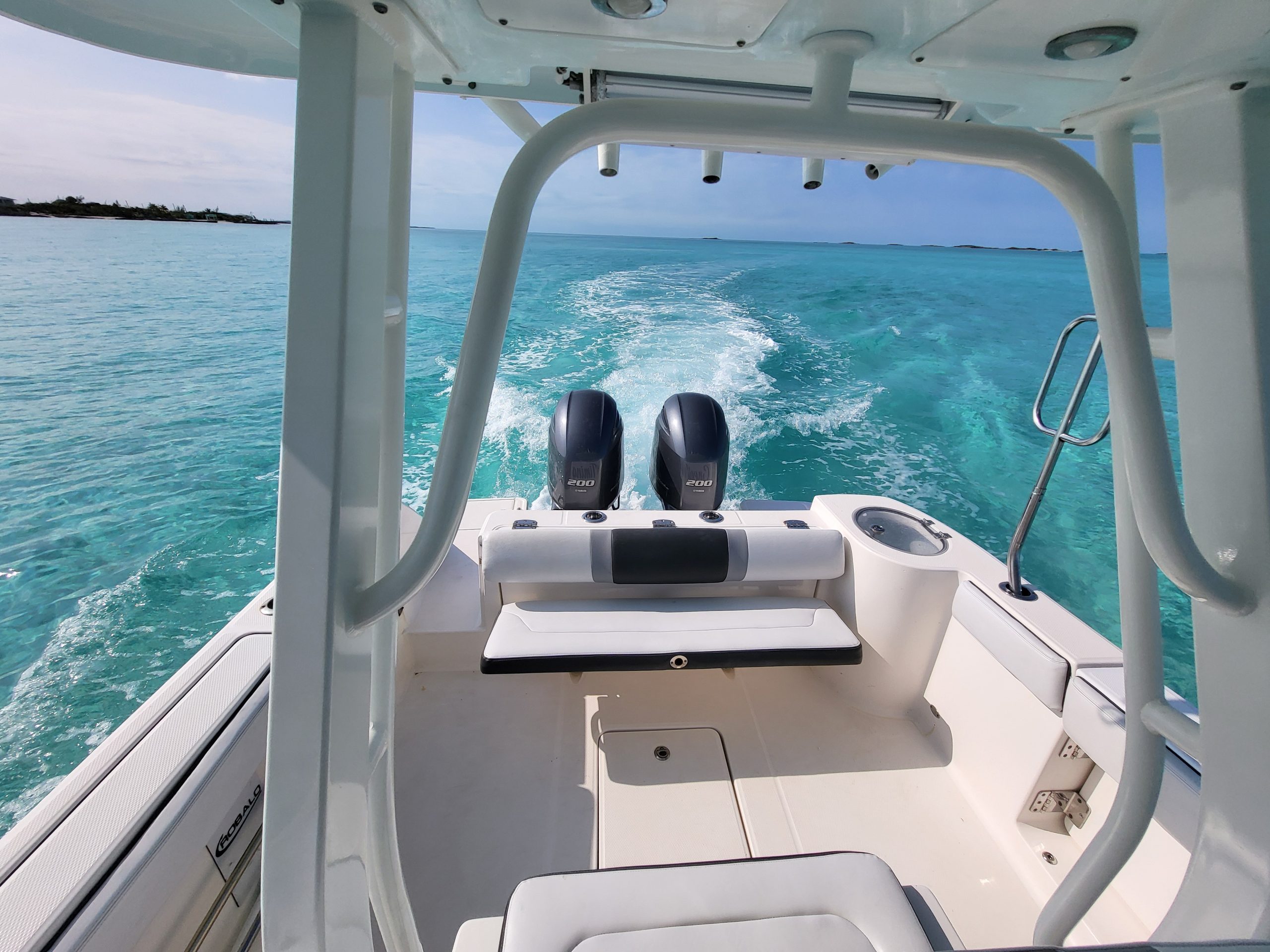 Staniel Cay, Exuma Bahamas Powerboat cruising on clear blue water with twin outboard engines.