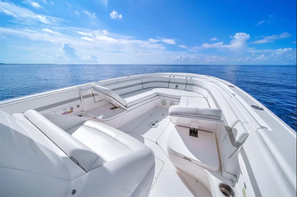 Staniel Cay, Exuma Bahamas The bow seating area of a white boat on calm blue water under a bright sky with scattered clouds. Swimming Pigs Tours, Fishing and more!