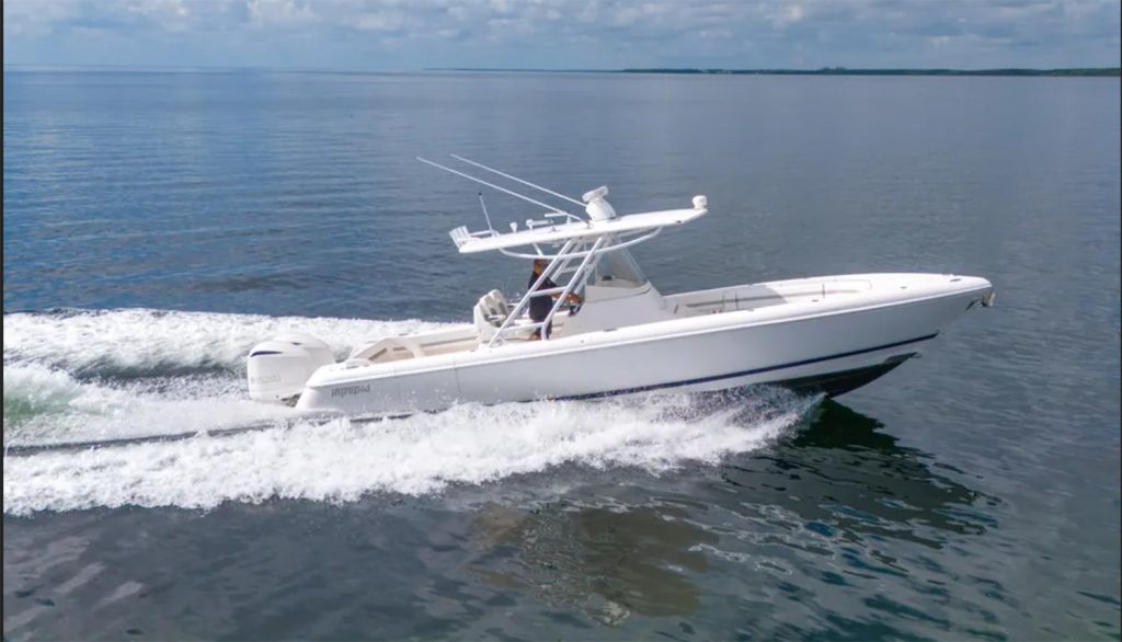 Staniel Cay, Exuma Bahamas A white motorboat with two outboard engines moves quickly across calm water under a partly cloudy sky. Swimming Pigs Tours, Fishing and more!